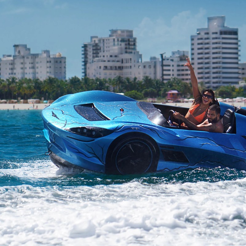 a small boat in a body of water with a city in the background