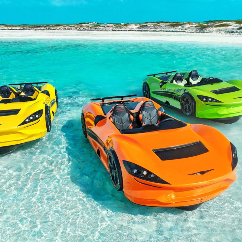 a close up of a toy car next to a body of water